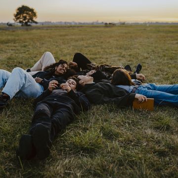 a group of people lying on the grass