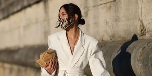 paris, france   march 06 yoshino mia yoshinomia wears a protective face mask with vintage dior monogram scarf upcycling, a white oversized blazer jacket  dress from sundarbay, a beige leather bag from mango, on march 06, 2021 in paris, france photo by edward berthelotgetty images