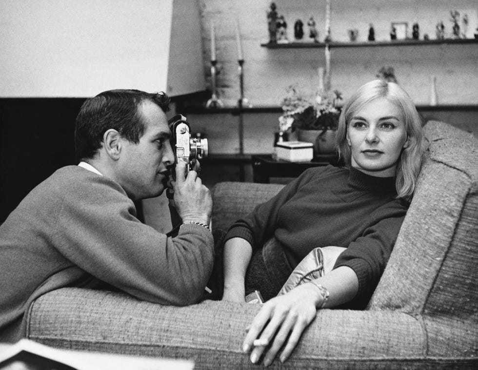 View of married American actors Paul Newman (1925 - 2008) and Joanne Woodward, the former of whom photographs the latter, in their Greenwich Village apartment, New York, New York, circa 1961.