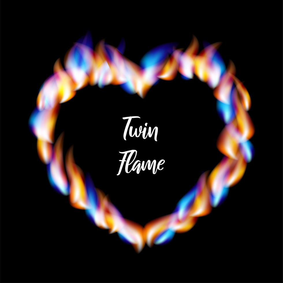 heart shaped frame made of orange and blue flames with the inscription twin flame twin flame vector illustration on black background for web sites and much more