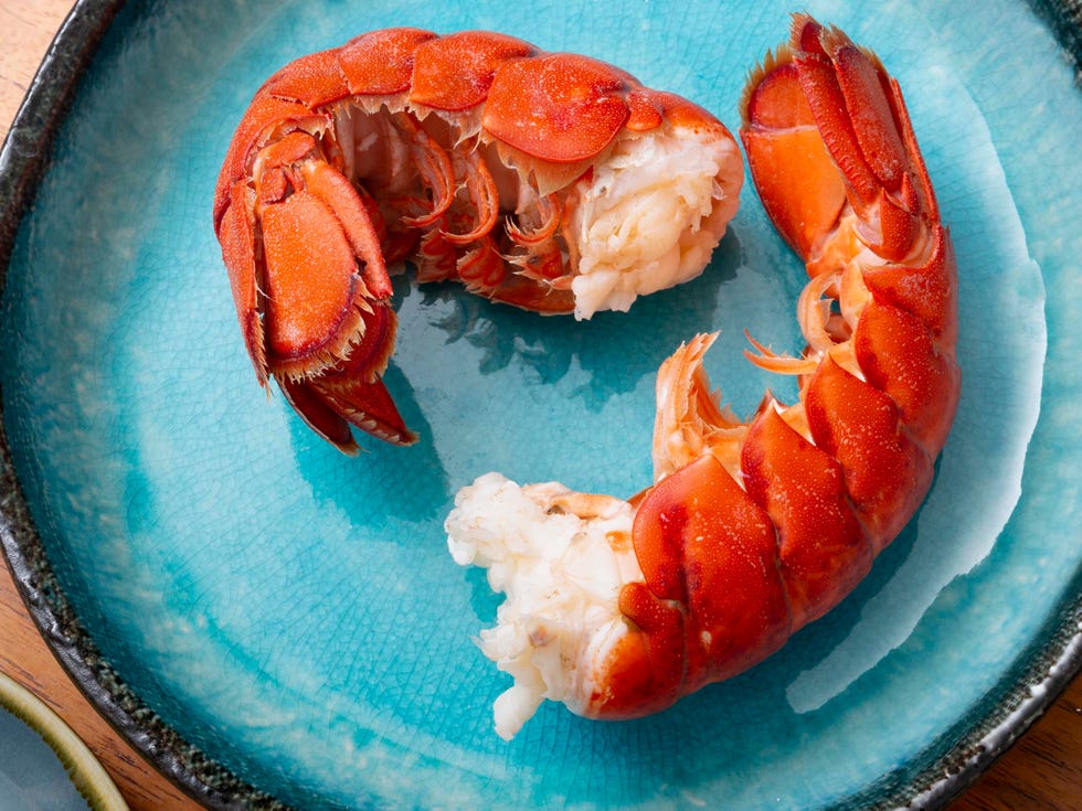 plate of lobster with lemon zest on wood