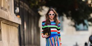 paris, france   april 08 therese hellström tesshell wears white cat eye sunglasses, a multi colored striped wool midi dress with long sleeves, a brown leather hermes bag, green pointed shoes with metallic pearls, on april 08, 2021 in paris, france photo by edward berthelotgetty images