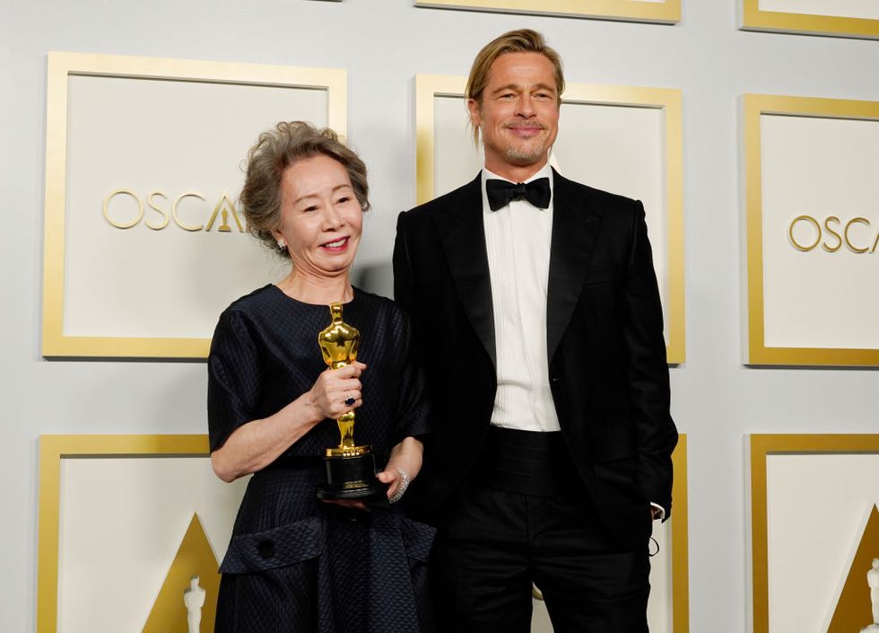 los angeles, california   april 25 l r yuh jung youn, winner of best actress in a supporting role for minari, poses with brad pitt in the press room at the oscars on sunday, april 25, 2021, at union station in los angeles photo by chris pizzello poolgetty images