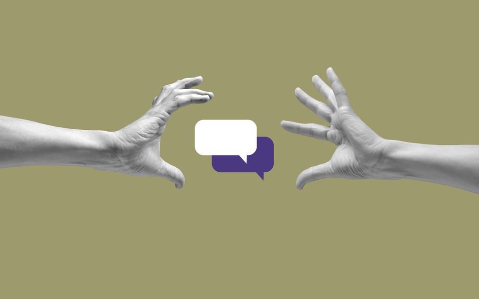 speech bubbles between two human hands against khaki background