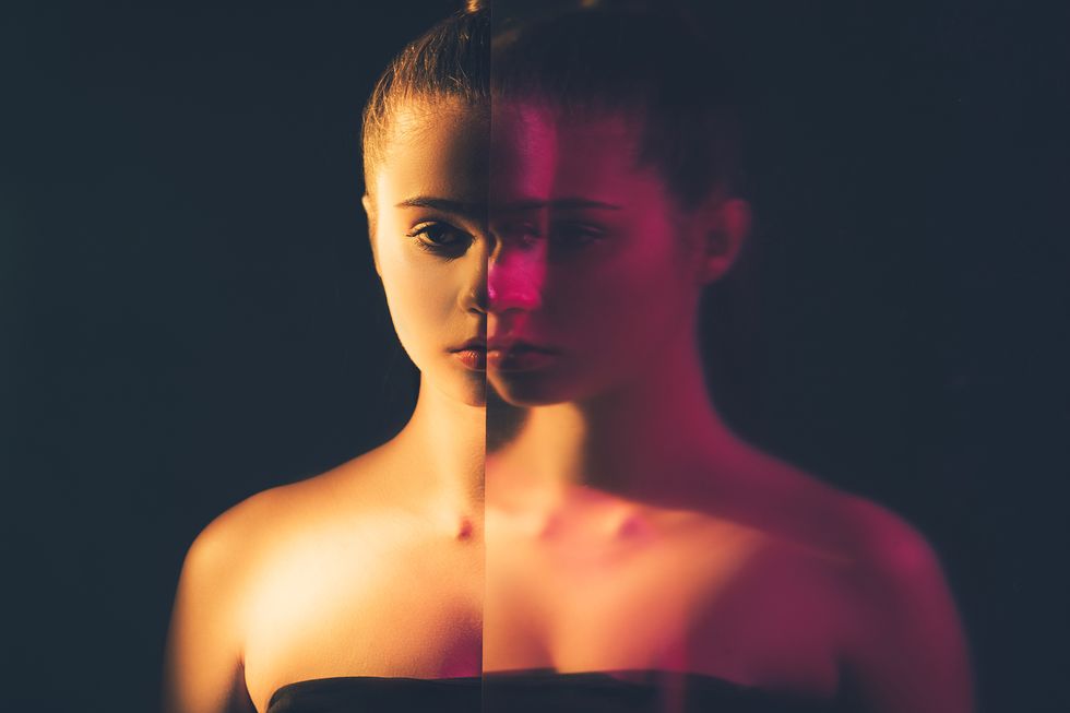 bipolar disorder mental health depresion loneliness double exposure silhouette night half face portrait of apathetic woman with mirror reflection out of focus in pink neon light isolated on dark