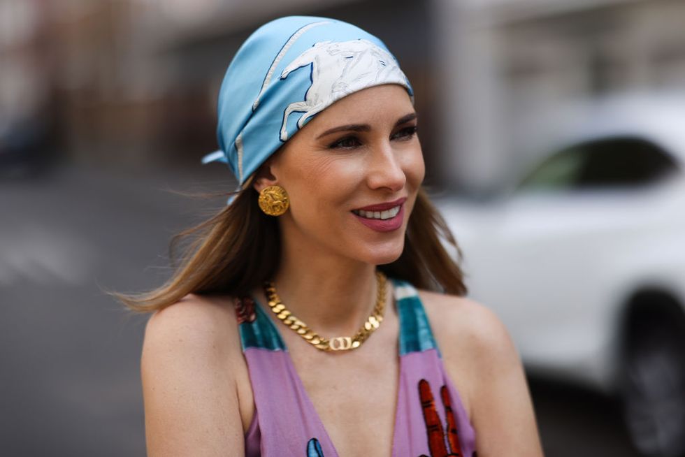 dusseldorf, germany   may 03 alexandra lapp wearing colorful valentino dress, blue hermès scarf, gold dior necklace and gold chanel earring, all via superbrands secondhand store on may 03, 2021 in dusseldorf, germany photo by jeremy moellergetty images