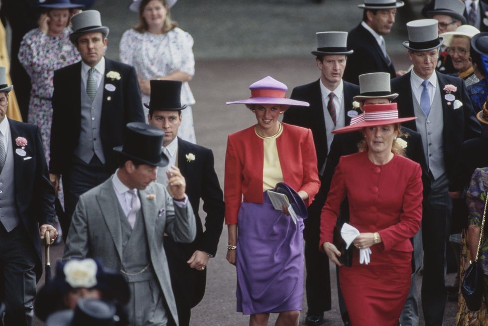 british royals charles, prince of wales, wearing a grey suit, prince andrew, duke of york, wearing a black suit, diana, princess of wales 1961 1997, wearing a red and purple suit by catherine walker with a hat by philip somerville, and sarah, duchess of york, wearing a red dress with a red hat with white trim, among the racegoers on the first day of the royal ascot race meeting at ascot racecourse in ascot, berkshire, england, 19th june 1990 photo by tim graham photo library via getty images
