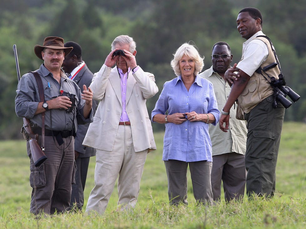 prince charles, prince of wales looks through binoculars beside camilla, duchess of cornwall