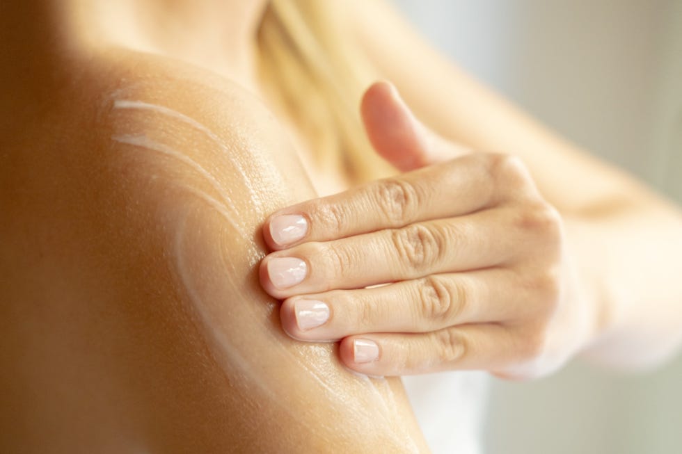 woman lathering body wash on skin