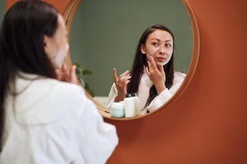 woman applying moisturiser