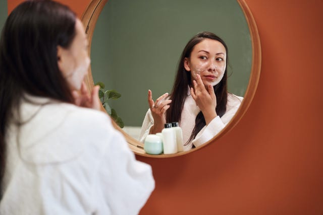 woman applying moisturiser