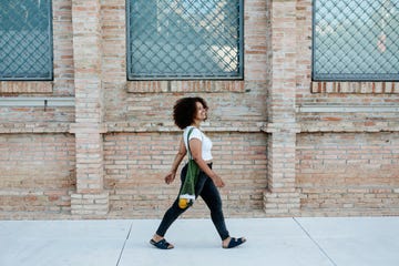 young curvy afro woman walking in the city copy space for text