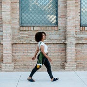 Happy woman walking in the street young curvy afro woman walking in the city copy space for text