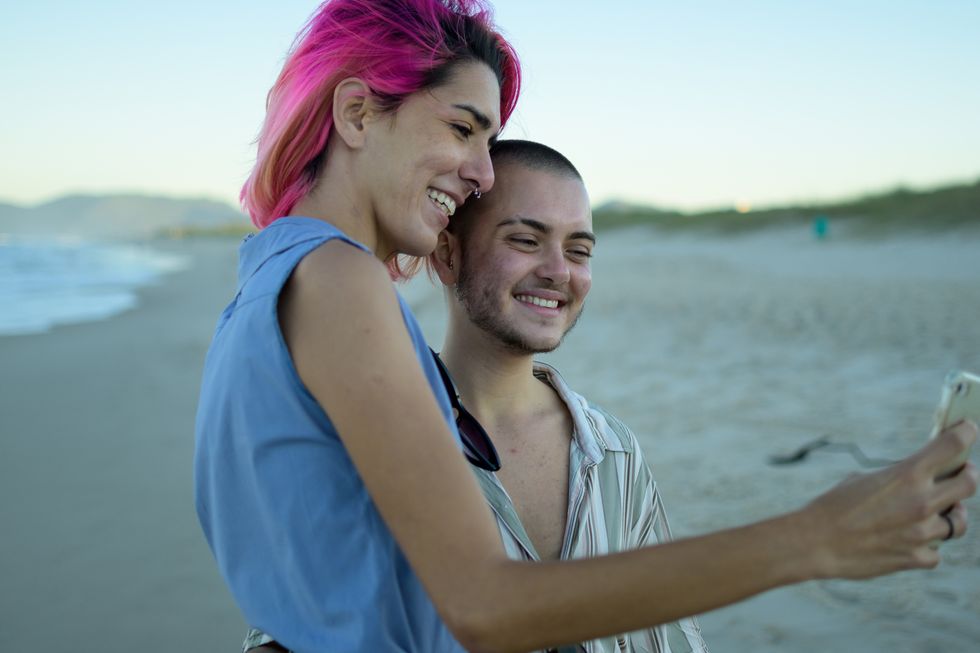 transgender couple enjoying the beach during their summer vacation