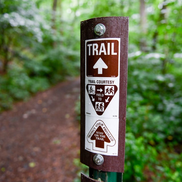 lower alsace township, pa   june 22 a trail marker that reads trail with an arrow, a graphic that reads trail courtesy with a graphic instructing people on bicycles to yield to runners and hikers, and runners to yield to hikers, then an arrow with the text protect your privilege, stay on the trail in the neversink mounatin preserve in lower alsace township tuesday afternoon june 22, 2021 photo by ben hastymedianews groupreading eagle via getty images