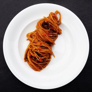 spaghetti all'assassina pasta, a speciality from bari, puglia, italy, top view
