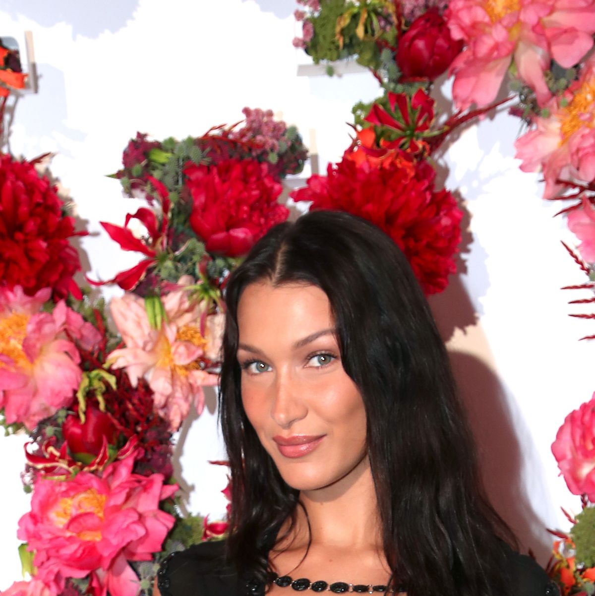 bella hadid rocks neon vest over a short white dress as she