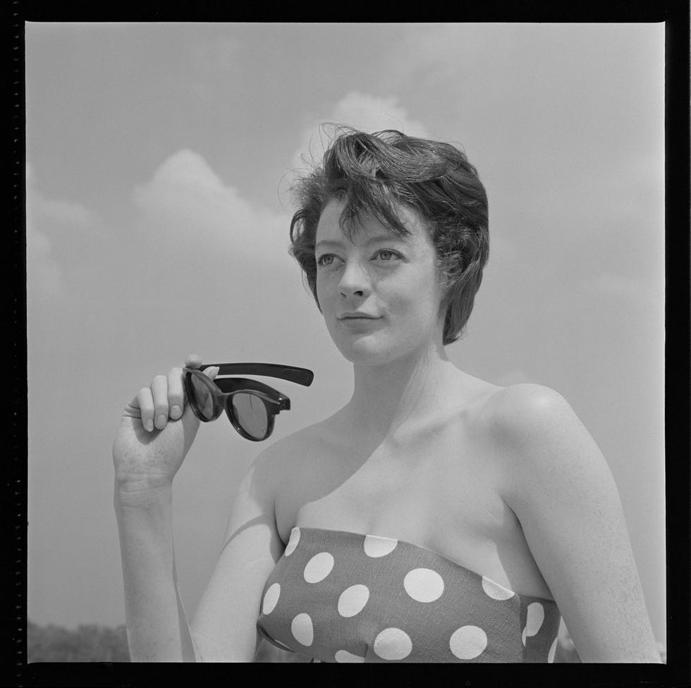 actress maggie smith posed with a pair of sunglasses, circa 1965
