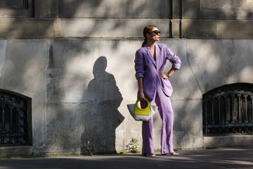 paris, france july 16: julia comil wears a pastel purple lavander linen oversized blazer by maryam nassir zadeh, pastel purple lavander linen high waisted pants by maryam nassir zadeh, purple bras by maryam nassir zadeh, sonia rykiel gray tortoise sunglasses, a cartier watch, yellow leather trimmed canvas small tote bag with round handle by hereu, white heeled sandals square toe by by far, on july 16, 2021 in paris, france. (photo by edward berthelot/getty images)