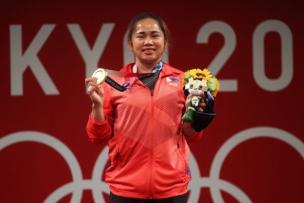 tokyo, japan   july 26  gold medalist hidilyn diaz of team philippines poses with the gold medal during the medal ceremony for the weightlifting   womens 55kg group a on day three of the tokyo 2020 olympic games at tokyo international forum on july 26, 2021 in tokyo, japan photo by chris graythengetty images