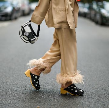 paris, france   july 29 gabriella berdugo wears a beige pyjama suit blazer jacket and matching pants with feathers details at hems from sleepers, black clogs  sandals with floral print, a black and white round checkered bag from balmain, on july 29, 2021 in paris, france photo by edward berthelotgetty images