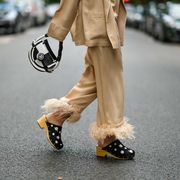 paris, france   july 29 gabriella berdugo wears a beige pyjama suit blazer jacket and matching pants with feathers details at hems from sleepers, black clogs  sandals with floral print, a black and white round checkered bag from balmain, on july 29, 2021 in paris, france photo by edward berthelotgetty images