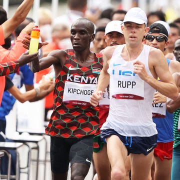 Athletics Marathon - Olympics: Day 16 sapporo, japan august 08 eliud kipchoge of team kenya, left, takes a drink as he competes in the mens marathon final on day sixteen of the tokyo 2020 olympic games at sapporo odori park on august 08, 2021 in sapporo, japan photo by clive brunskillgetty images