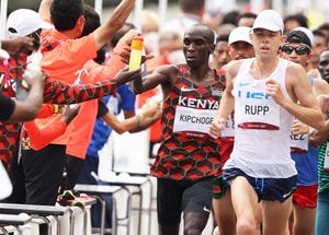 sapporo, japan august 08 eliud kipchoge of team kenya, left, takes a drink as he competes in the mens marathon final on day sixteen of the tokyo 2020 olympic games at sapporo odori park on august 08, 2021 in sapporo, japan photo by clive brunskillgetty images