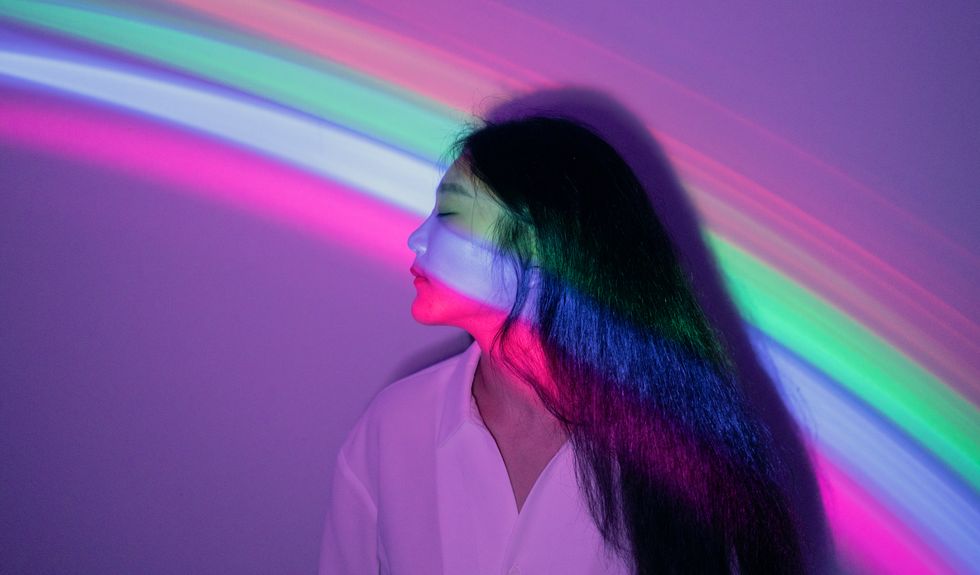 young asian woman on rainbow background