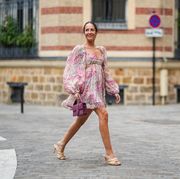 paris, france   august 04 alba garavito torre wears earrings, a pale pastel pink mini low neck gathered and pleated floral print dress with puff shoulders  sleeves and ruffles, a purple jacquemus bag, bottega veneta wicker sandals shoes, on august 04, 2021 in paris, france photo by edward berthelotgetty images