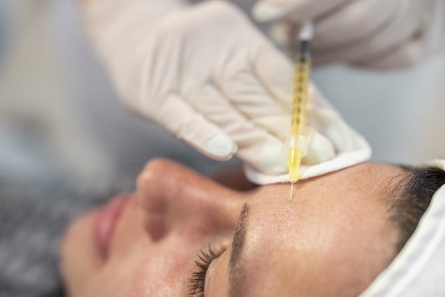 close up of female patient's face during hyaluronan treatment