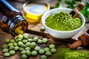 moringa oleifera powder and pills on rustic table