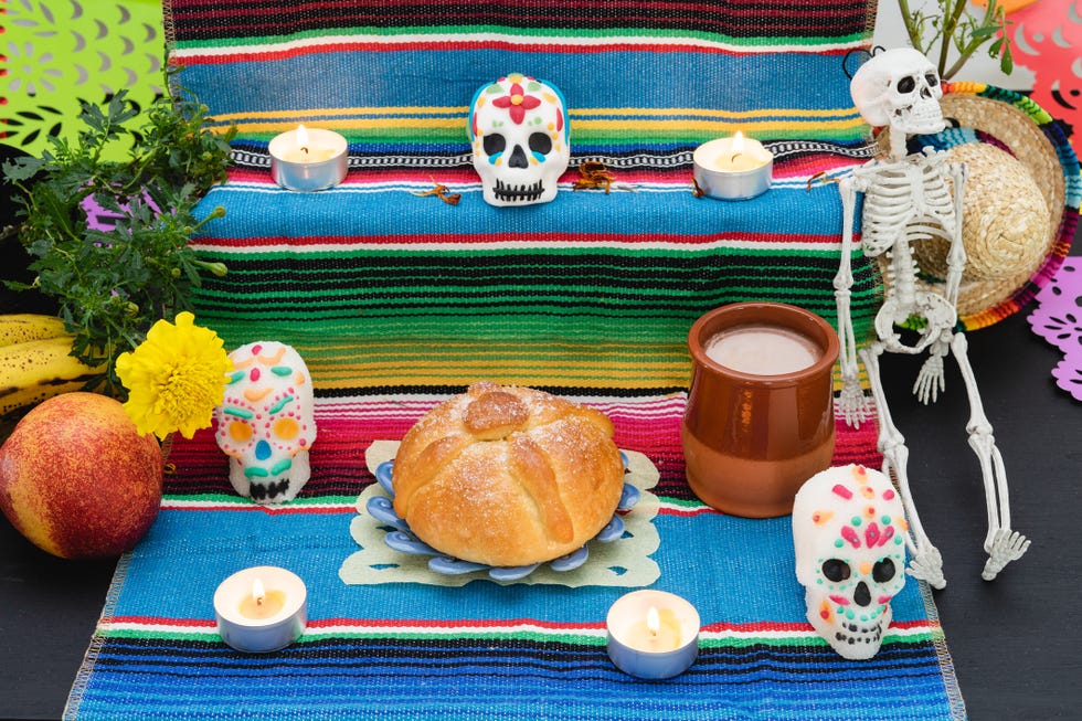 altar decorated with pan de muerto and skulls day of the dead mexican holiday