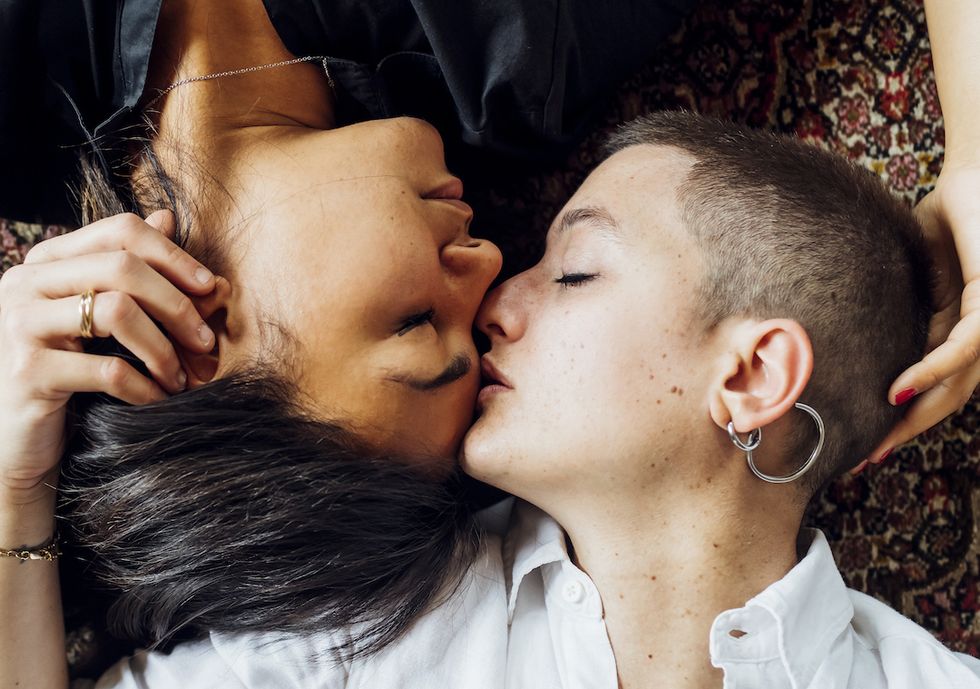 lesbian couple at home cuddling in love milan, lombardy, italy diversity, queer family, relationship concept