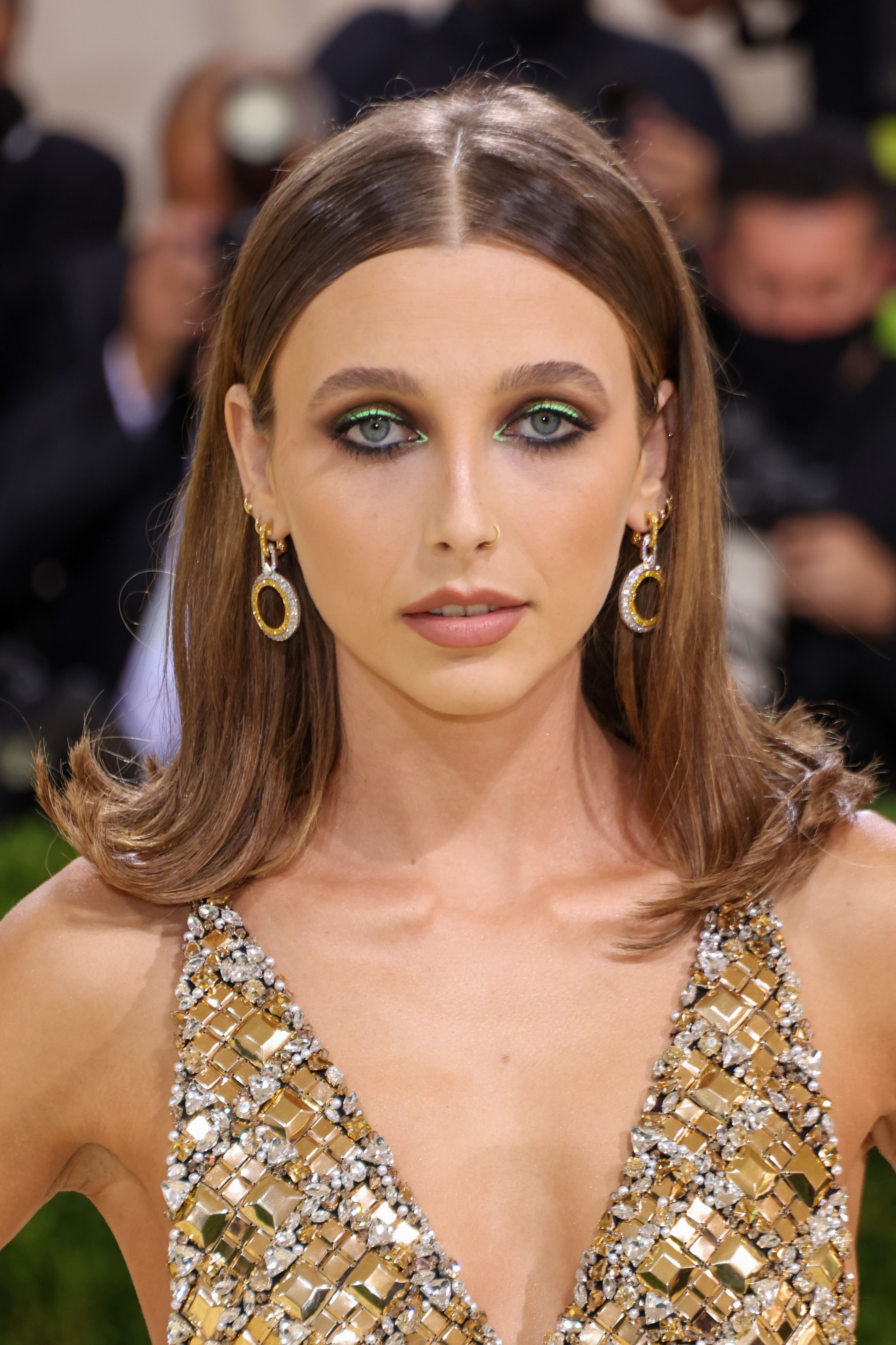 Emma Chamberlain glistened from head to toe in a gold dress with daring  cutouts at the Met Gala