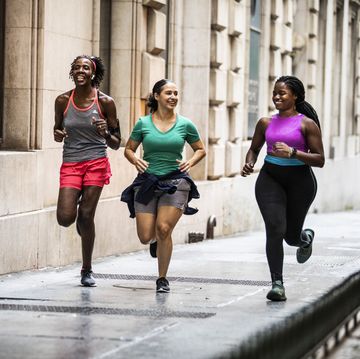 group of women running Hol through urban area