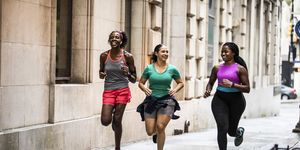 group of women running buscando through urban area