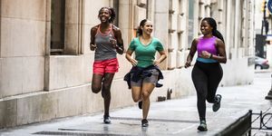 group of women running Hol through urban area