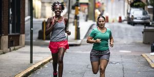 two women running through urban area