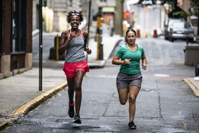 two women running through urban area