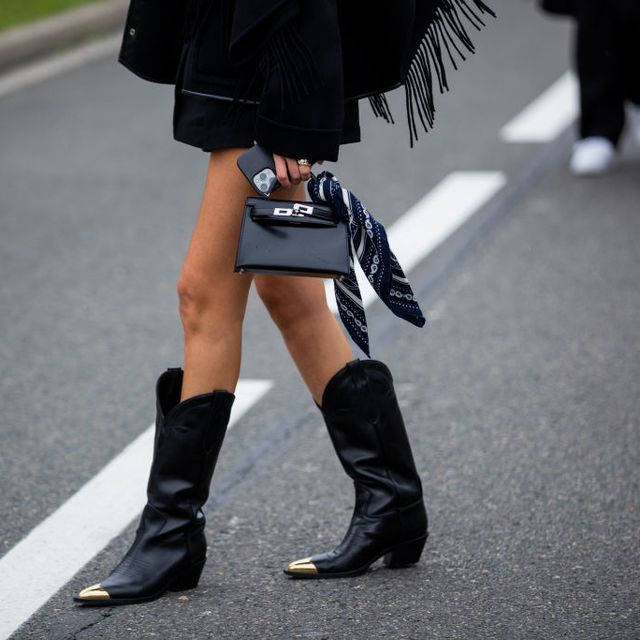 a woman wearing black cowboy boots