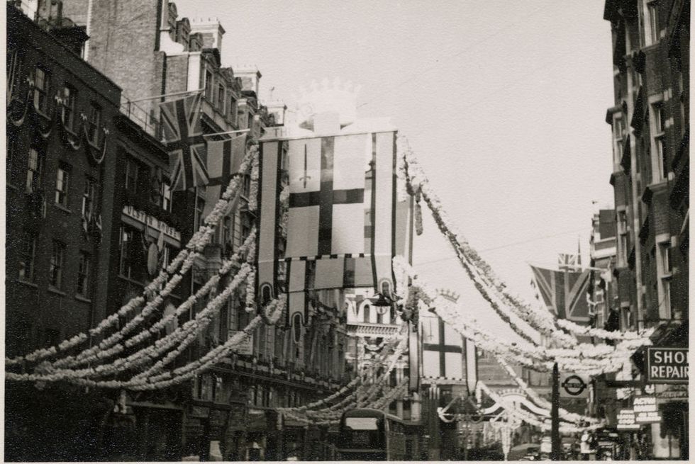 fleet street, city of london, greater london authority, 1953 a view of flags hanging from buildings and in the centre of fleet street, from which decorations are strung, for the coronation of elizabeth iithe coronation of elizabeth ii took place on 2nd june 1953 the flags hanging along the centre of fleet street in this photograph is the flag of the city of london, which features a red sword in the top left quarter of the st georges cross artist jr uppington photo by by historic englandheritage images via getty images