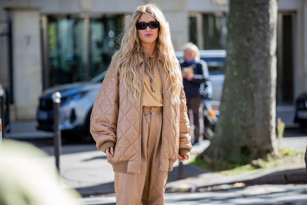 paris, france   october 05 emili sindlev seen wearing beige pants, puffer jacket outside miu miu during paris fashion week   womenswear spring summer 2022 on october 05, 2021 in paris, france photo by christian vieriggetty images