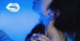 portrait emphasizing a womans neck and ear with cool blue lighting