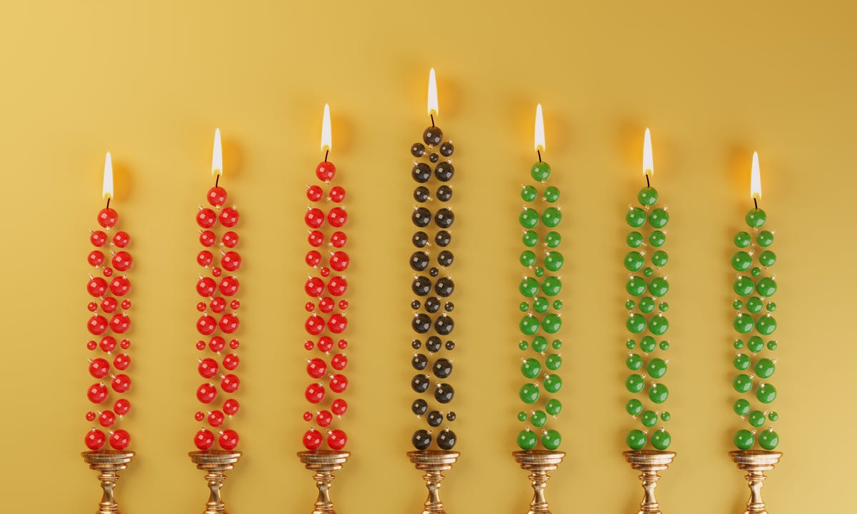 red, green and black candles with ornaments flat lay, symbolizing kwanzaa concepts