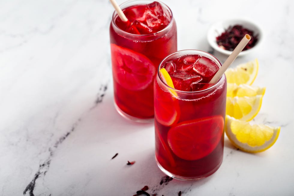 lemon hibiscus tea served cold with ice and bamboo straw