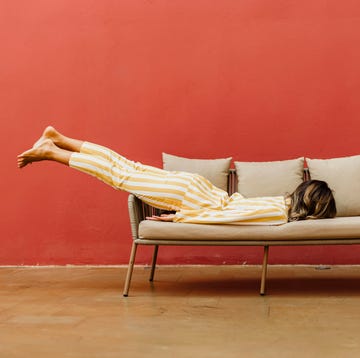 tired young woman sleeping on sofa