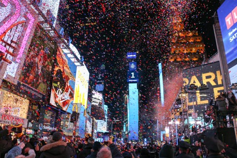 new years eve celebration in times square with confetti and crowds