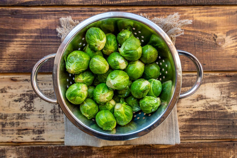 how to freeze brussels sprouts colander filled with fresh green brussels sprouts