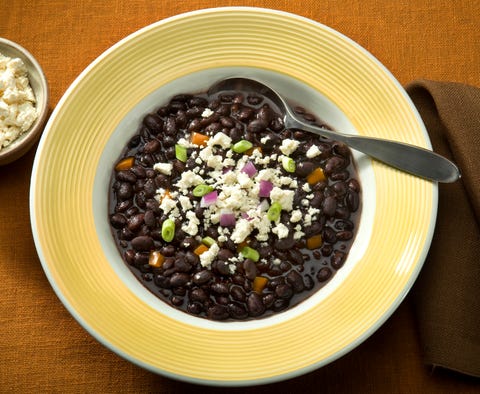 elegant, contemporary bowl of black bean soup small side of mexican cheese with cheese crumbled on too of soup hi res, hi saturation